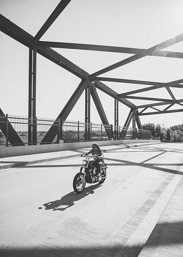 united states grayscale photo of man riding motorcycle on bridge minneapolis